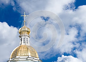 Golden church dome on cloudy sky background