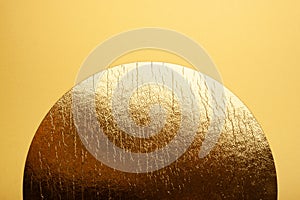 Golden circle on a yellow background.