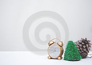 Golden clock and Christmas decoration on white background with copy-space, family spent time together in winter Christmas holiday