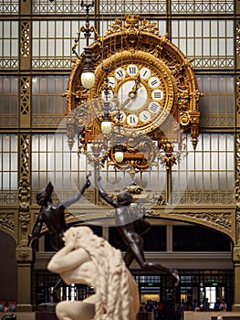 Golden clock by Victor Laloux at the Musee d`Orsay, Paris, France