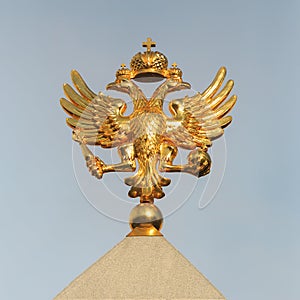 Golden Coat of arms of the Russian Federation close-up on the background of the sky