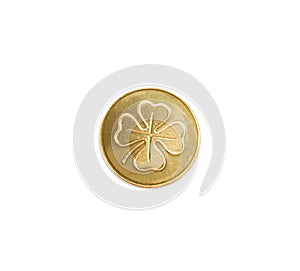 Golden coin with four leaf clover