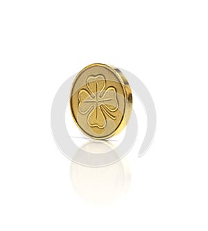 Golden coin with four leaf clover