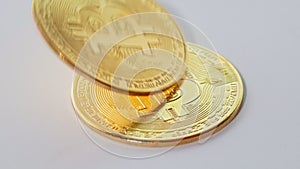 Golden coins with bitcoin symbol on a stack of coins isolated on white background. Bitcoin and cryptocurrency trading system.