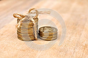 Golden Coins With Rope On Wood Table