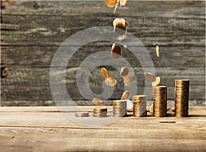 Golden coins stacks on wooden background