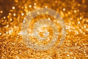 Golden color abstract glitter texture background for holidays with bokeh