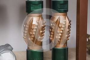 Golden color rock drilling calibrator on shelving in stock. Oil drilling equipment for drilling rig operation on oil