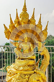 Golden color statue of Buddha and dragons in the temple in Phuket. Thailand