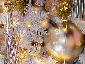 The golden color on the white christmas tree decoration. The dec