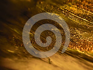 Golden colored abstract paint background photo
