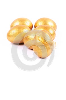 Golden colored Easter eggs isolated on white background. Place for text.