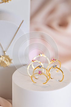 Golden colored rings and other girl accessories on jewelry display stands