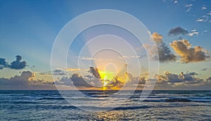 Golden colorful sunrise sunset with sunbeams tropical beach Tulum Mexico