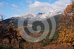 Snow-clad Siete Picos mountain in Guadarrama National Park with cloudy blue sky in Cercedilla, Madrid photo