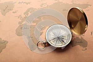 Golden compass on vintage world map. Travel planning concept