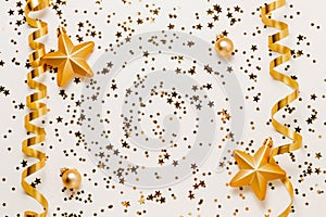 Golden confetti stars background with christmas toys and ribbons