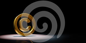 Golden Copyright Symbol Spotlighted on Black Background 3D Illustration