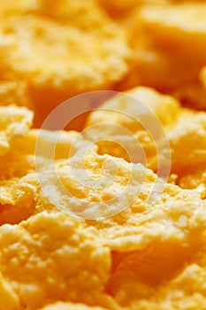 Golden cornflakes background and texture. View from above. cornflakes healthy breakfast, macro