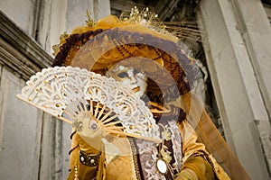 Golden costumed masked woman