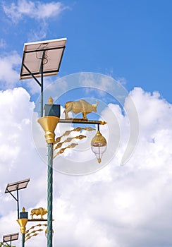 golden cow light bulb and solar energy with blue sky background