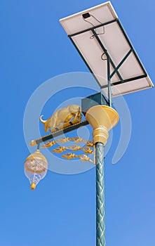 golden cow light bulb and solar energy with blue sky background