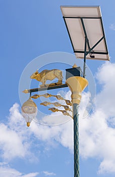 golden cow light bulb and solar energy with blue sky background