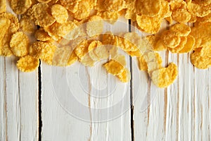 Golden crisp cereal for breakfast on a white wooden background