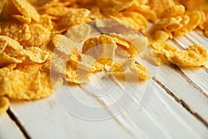 Golden crisp cereal for breakfast on a white wooden background