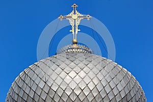 Golden cross on metal dome roof of an orthodox church, Ukraine