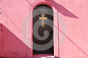 Golden cross on a metal door