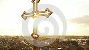 Golden cross of orthodox church with glitter on sky background