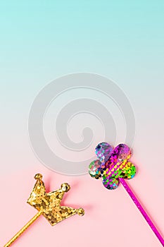 Golden crown and pink flower made of  round sequins on gradient pink and blue background. Fashion party accessories  with copy