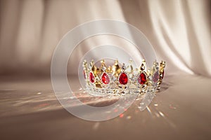 Golden crown with red gemstones, accesory for kings and queens, prince and princess. photo