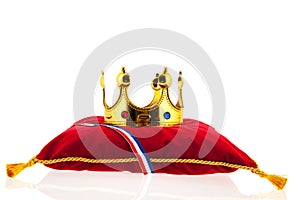 Golden crown on velvet pillow with Dutch flag