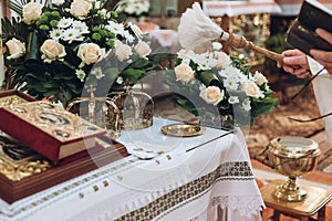 Golden crowns and bible and wedding ring on altar in church at wedding matrimony. traditional religious wedding ceremony photo