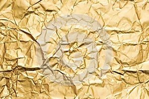 Golden crumpled foil paper texture abstract background