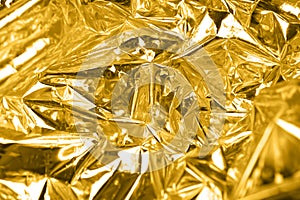 Golden crumpled paper, abstract background
