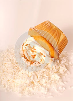 Golden cupcake with buttercream and coconut photo