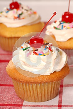 Golden cupcakes with buttercream and sprinkles photo