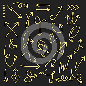 Golden curvy and odd shape hand drawn direction arrows and pointers set on black