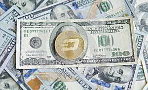 Golden Dash Cryptocurrency coin on a pile of US dollars, cash money and crypto currency concept. Virtual. Metal coins of