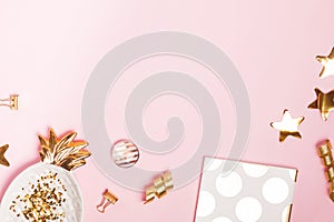 Golden decor and feminine accessories on the pink background,