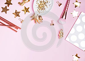 Golden decor and feminine accessories on the pink background