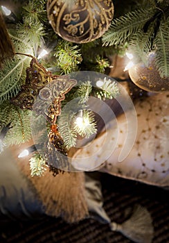 Golden decorations hanging on Christmas tree
