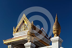 Golden decorations to buddhist temple, Bangkok. Clear Blue sky in background.