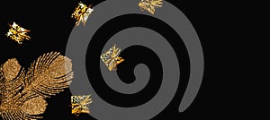 Golden decorative branch and small present boxes on black background.  Sales and shopping theme