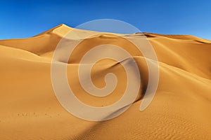 The golden desert wave and blue sky sunset in Tulufan city