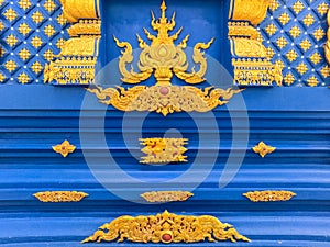 Golden details of ornamentation of Wat Rong Suea Ten Blue Temple at Chiang Rai Thailand