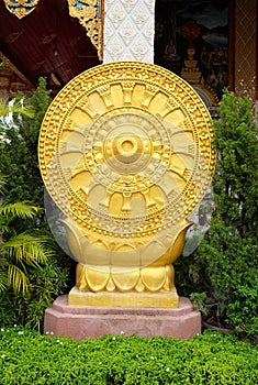 Golden Dharmachakra or Wheel of Dhamma symbol of Buddhism at temple in Thailand